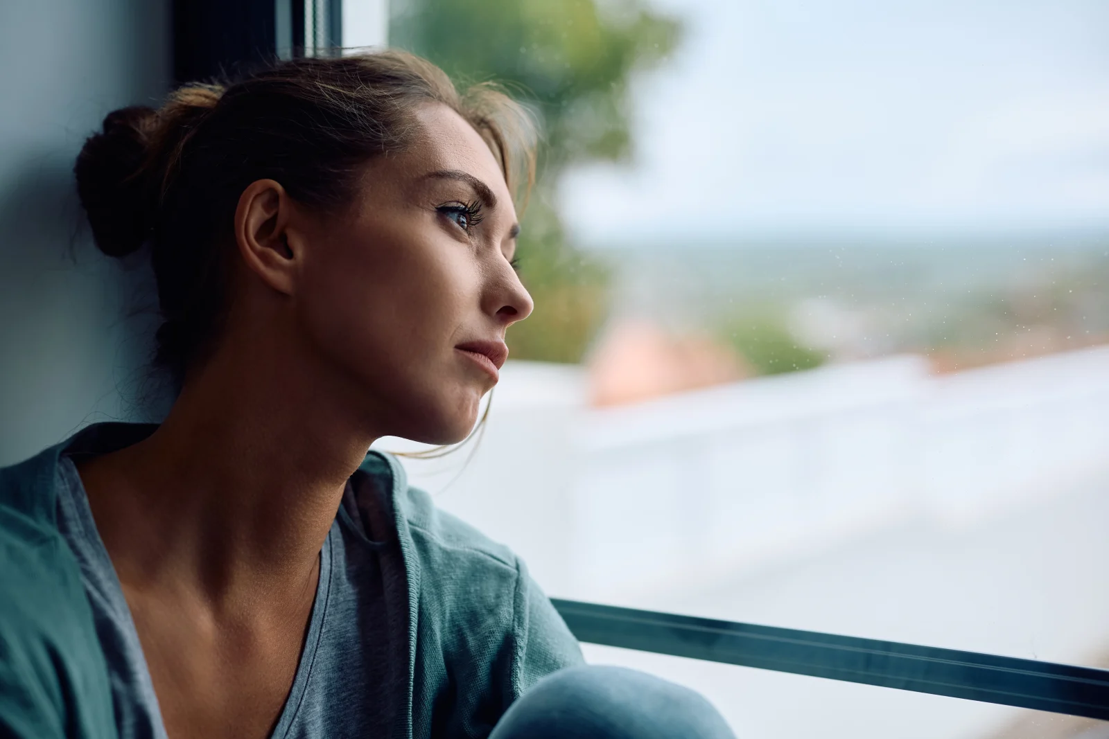 Woman gazing out of a window – online psychiatry in Clovis, NM